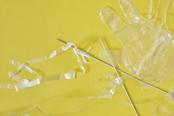 Recycled plastic yarn concept, knitting knitting needles and sliced polyethylene package