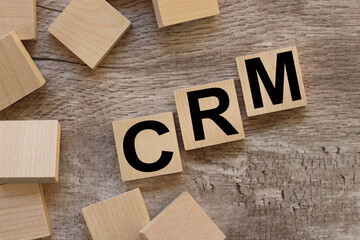 CRM. text on wood blocks. on a wooden table. Business concept