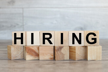 Hiring. text on wood blocks. on wood background