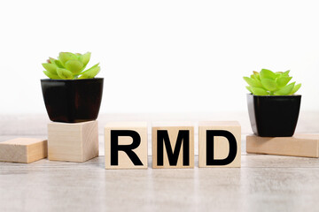 RMD. text on wooden boards on white background on wooden table