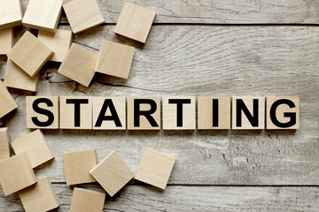 Starting. wooden cubes on a wooden background. three wood blocks