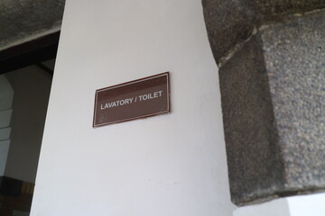 Lavatory toilet sign in the wall