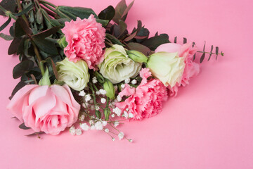 A bouquet of flowers on a pink background