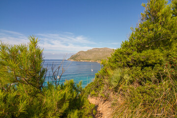 Turquoise water, rocky coast line and boats at beautiful beach Cala na clara near Betlém at Mallorca island, Mediterranean Sea, Spain