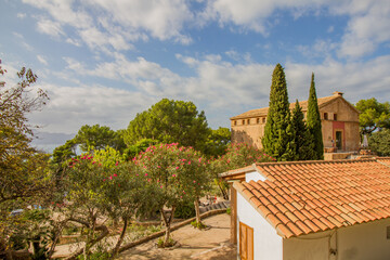 Typical mediterranean buildings and vegetation at the monastery Ermita de la victoria near...