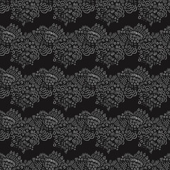 Abstract black and white hand-drawn pattern. Fashionable geometric ornament of dashes, strokes, curves, lines, signs. Design of background, template, fabric, textile, wallpaper, clothing, packaging.