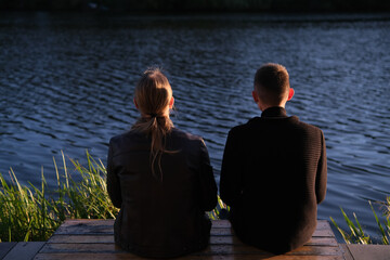 teenager friends boy couple sitting on a bench