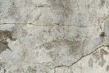 An empty concrete surface with cracks and traces of old paint. The background is a painted old wall. A place to insert text or design.