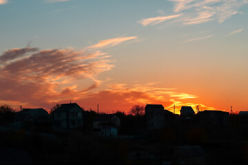 The sky at sunset. Silhouettes of houses.