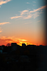 The sky at sunset. Silhouettes of houses.