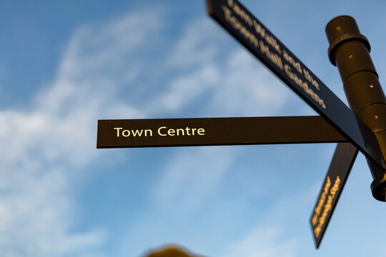 Town centre sign in a popular British seaside tourist destination, it is isolated against a blue sky with light clouds