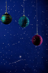 A New Year's card with a place for congratulations. Big beautiful balls as decoration on a blue background with stars