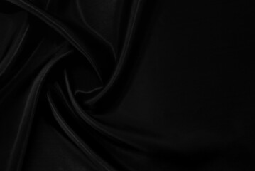 Part of the dark fabric texture of the fabric for the background and decoration of the work of art, a beautiful crumpled pattern of silk or linen. A crumpled piece of cloth