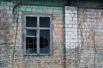 Broken window of an old brick house. Kiev, Ukraine.