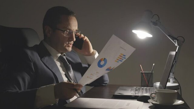 Financial director preparing company report, working late at the office