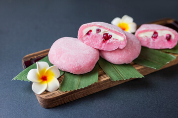 delicious japanese cuisine dessert mochi pink brownies with butter cream and currants with bumbu leaves