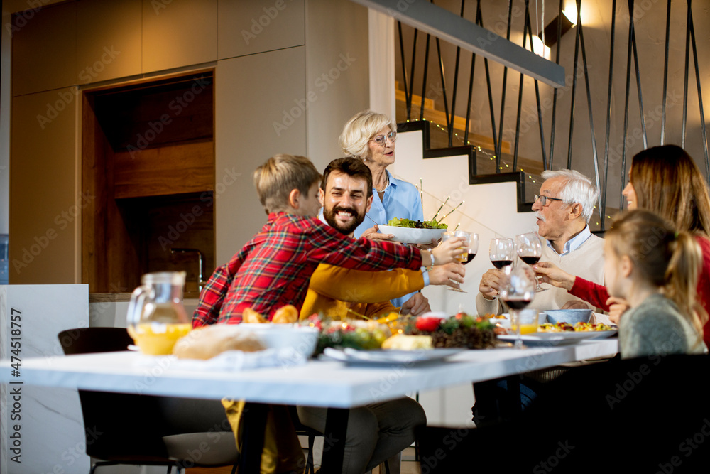 Wall mural happy family having dinner with red wine at home