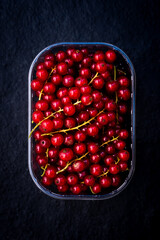 fresh cranberry in a pan. Black background. Top view.
