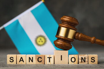 Judge gavel, wooden cubes with the text on the background of the Argentine flag, the concept on the...