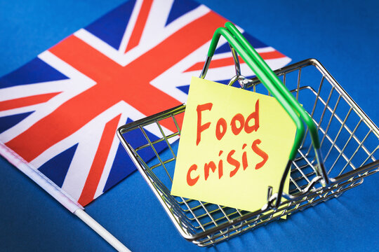 British Flag And Note With Text In Empty Food Basket On Colored Background, UK Food Crisis Concept