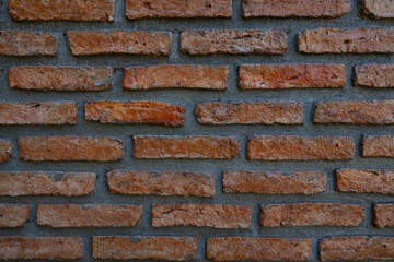 Fototapeta premium Texture of old dark brown and red brick wall background. Close-up