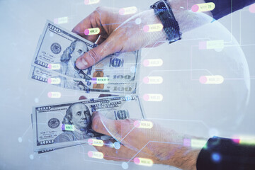 Multi exposure of technology drawing hologram and us dollars bills and man hands. Data concept