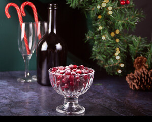 Poudered sugar cranberries on transparent bowl for cocktail or drinks. Christmas and New Year celebrating.