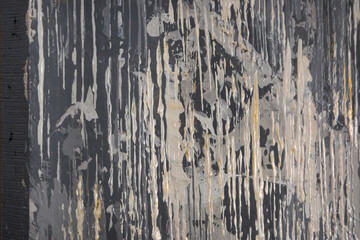 Side view of a canvas with flowing white and gray paint