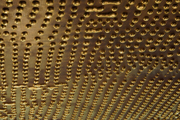 Round drops and drips of gold metal, inverted board