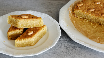 Portion of cake with fenugreek seeds and semolina. Sweet traditional helbeh dessert.