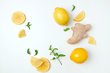 Fresh ginger and lemon on white background. Flat lay, top view, copy space. Seasoning, spice, ingredient for tea