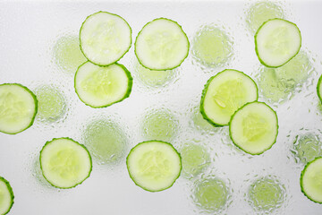 Fresh cucumber with many round slices background.