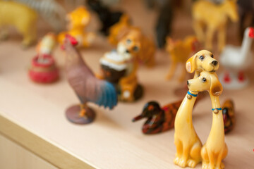 Figure of two dogs witn the bakground of many little toys of birds and animals.  Love concept background