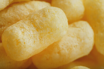 Corn sticks in powdered sugar as a texture, crispy sweets