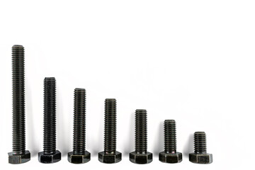 Background made of black screws with a hardness of 4.8, isolated on a white background, visible small and large screws.