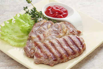 Grilled pork neck steak with ketchup
