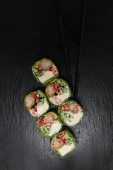 Japanese cuisine sushi on a plain light green background Caesar salad with shrimp photo for the menu on a solid background pasta