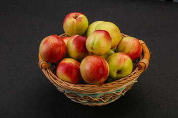 Sweet small nectarines in the basket