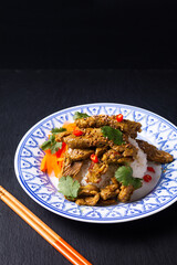 Food concept homemade Turmeric Stir Fried Beef with rice on black slate stone board with copy space