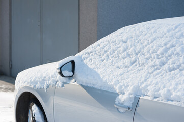 A part of the car covered with a layer of snow