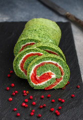 Sliced spinach roll with salted (smoked) red fish (salmon, trout) and cream cheese (ricotta)...