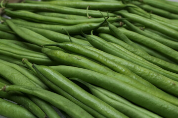 Close-up of fresh green beans lined up. Immature pods of common beans. Vegetable for vegetarian. Food for vegan.