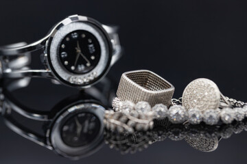 Elegant women's watches in a metal case and jewelry made of silver