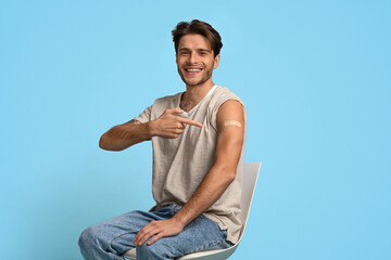 Get Vaccinated. Young Man Pointing At Adhesive Bandage On Arm After Vaccination