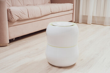 air purifier and air humidifier in the room, dry air humidification and water purification of indoor air, selective focusing, tinted image, sun glare