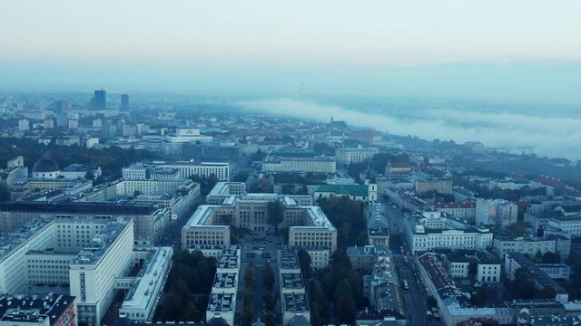 Forwards fly above town development. Large government buildings and palaces. Morning view before sunrise. Warsaw, Poland