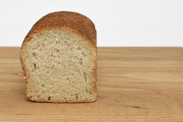 loaf of fresh grain bread on wooden table