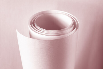 A large roll of paper in a warm color.