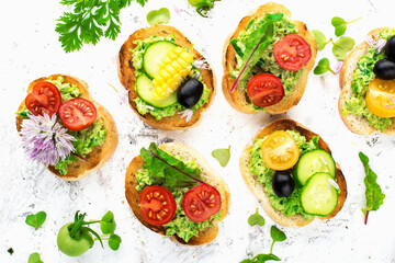 Tapas appetizer canapes with cheese and vegetables and microgreens. Top view .