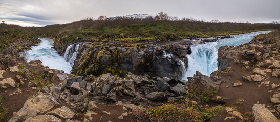 Picturesque waterfall Hlauptungufoss autumn view. Season changing in southern Highlands of Iceland.